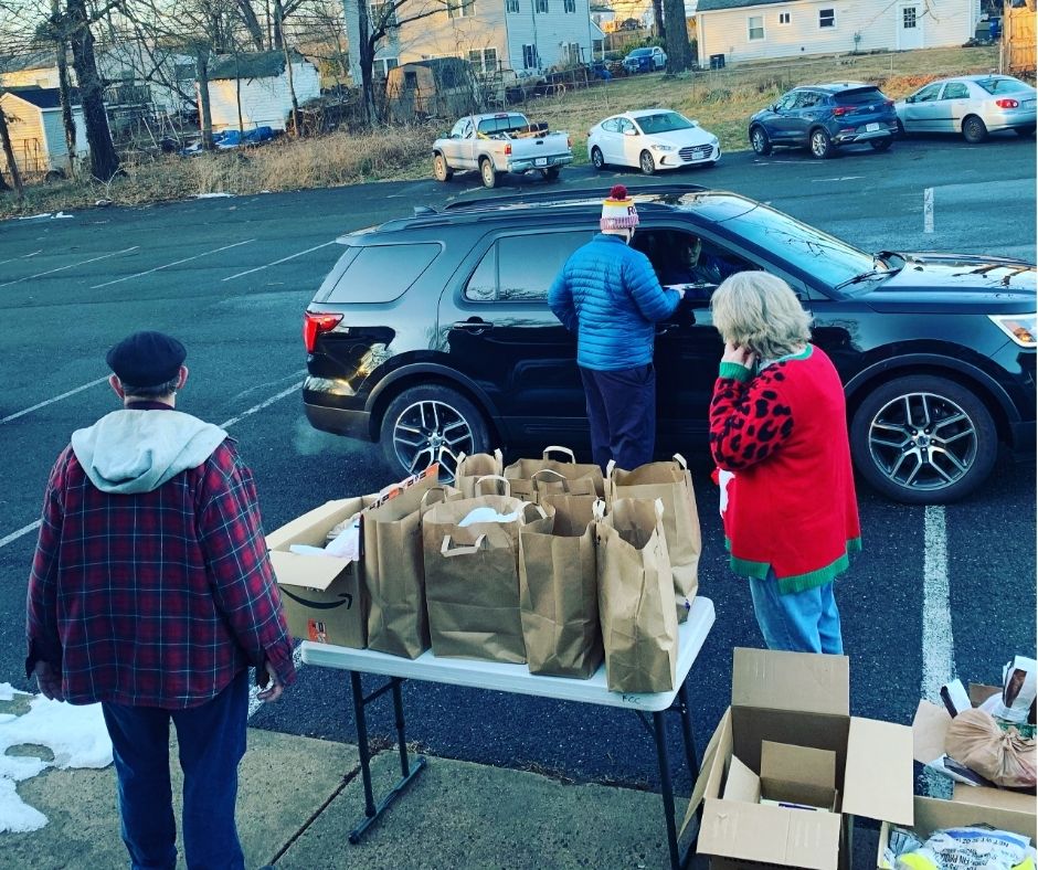 volunteers distributing bags of food